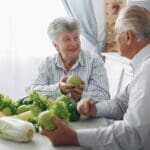 7 Easy Nutrition Tips for Staying Healthy as You Age in 2026 Couple enjoying a healthy meal. healthy aging